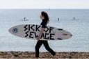 People take part in a protest by Surfers Against Sewage in Falmouth (Anthony Upton/PA Media Assignments)