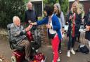 Tina Cleveland presents a certificate to Buxton Avenue resident Gilbert Baird, 103