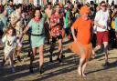 Christmas Day swimmers make a dash for the waves at Lowestoft.