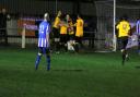 Fakenham Town's players mob Robbie Harris after his late, late equaliser. Picture: TONY MILES