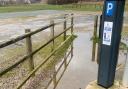 A puddle in front of a parking meter at Clink Road carpark in Sea Palling.