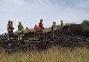 The fire service extinuishing the blaze on the dunes at Caister-on-Sea