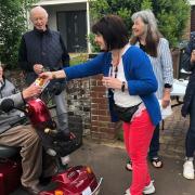 Tina Cleveland presents a certificate to Buxton Avenue resident Gilbert Baird, 103