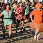 Christmas Day swimmers make a dash for the waves at Lowestoft.