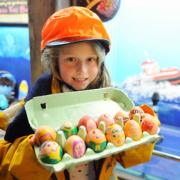 Caister Lifeboat holding a Easter Egg hunt over the bank holiday weekend. Scouts, guides and local school children have handmade the eggs for the visitors to find.Hannah King (dressed as a crew member) on holiday with her family holding some eggs