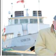 James McKee seen in 2011 and with the medal he was awarded with for his service to the maritime sector