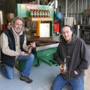 Russell and Archie Watson by their apple press in Scratby. Picture - Denise Bradley