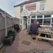 Regulars enjoying the good weather outside The Hermitage, Acle. Picture - James Weeds