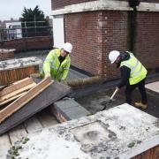 Andy Goddard, site foreman, and Jack Isbell, assistant contracts manager for Stroods working on the roof of the Iron Duke in Great Yarmouth.