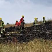 The fire service extinuishing the blaze on the dunes at Caister-on-Sea